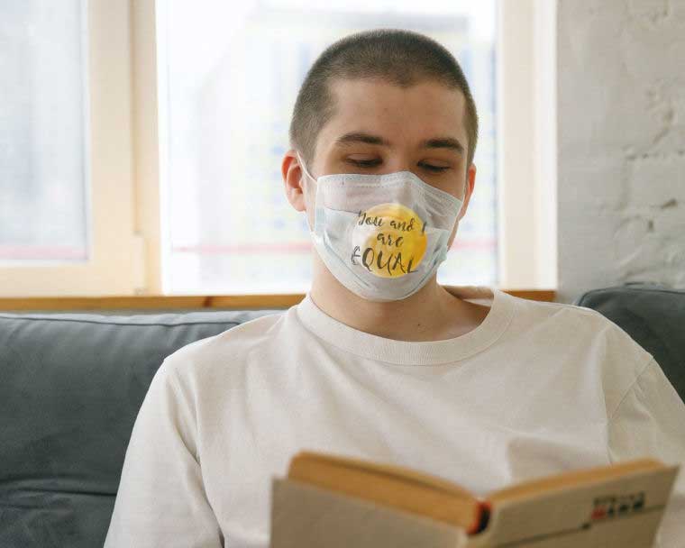 Boy with mask printed with You and I are equal